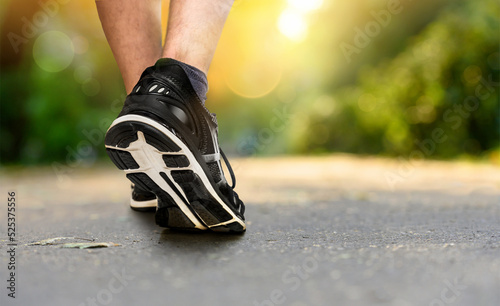 Legs of a jogger in shoes close-up in the park