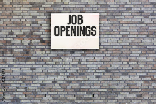 job openings written on brick wall with light box 