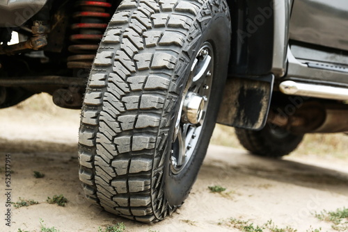 SUV wheel close up is on nature background in summer. mud tire close up is on off road car. 