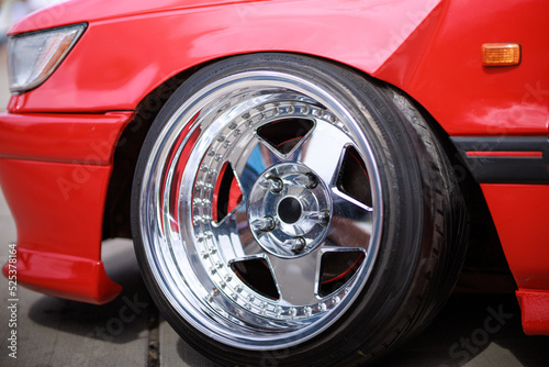 Tuned red sport car wheel, close up. Low rider sport auto. 