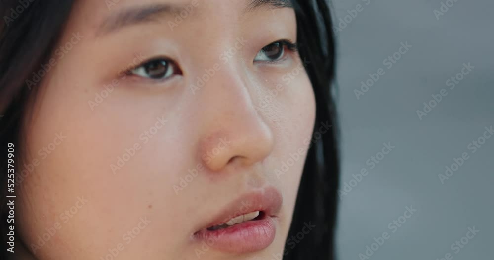 Portrait of asian brunette young woman opening brown eyes and looking up