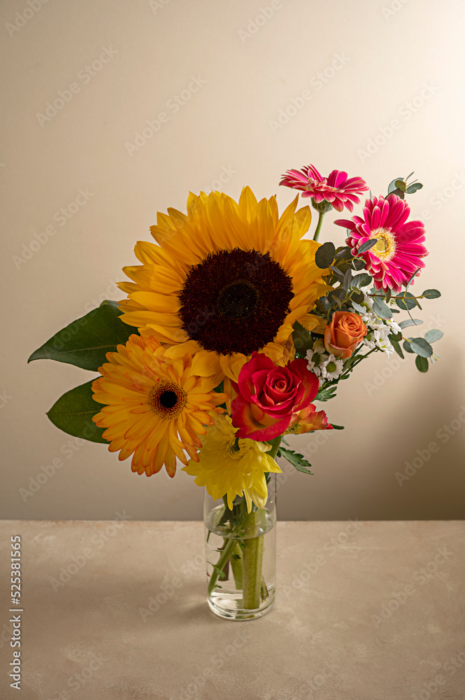 Autumn flowers. Bouquet of fresh gerber, sunflowers, roses, eucalyptusin glass vase, neutral warm background. Autumn flowers. Bouquet of fresh gerber, sunflowers, roses, eucalyptusin glass vase, neutral warm background.