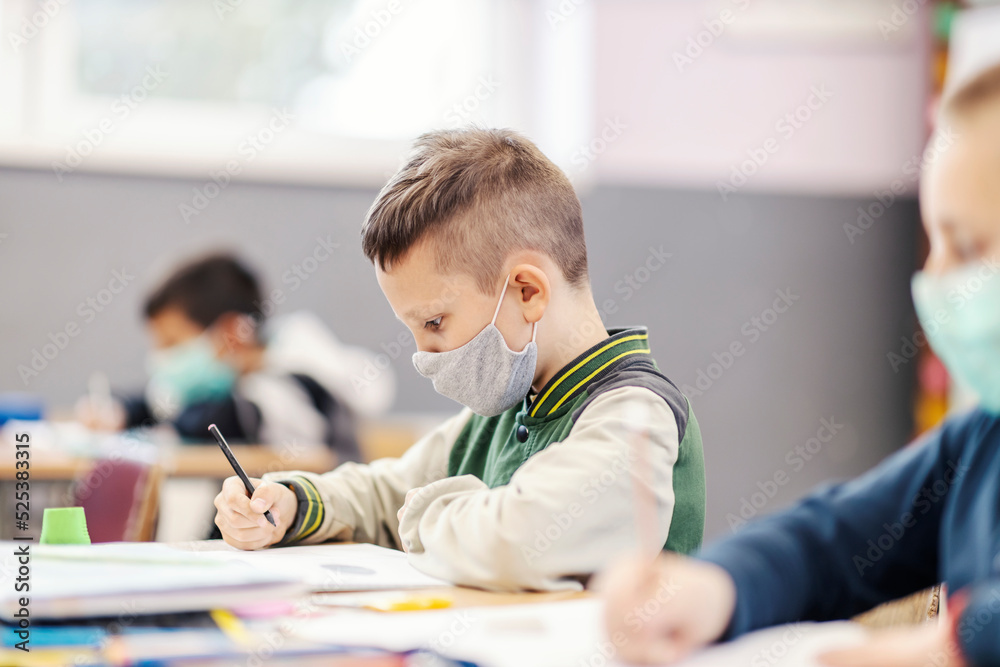 A pupil at class with his schoolmates learning new things during corona virus. A pupil at class with his schoolmates learning new things during corona virus.