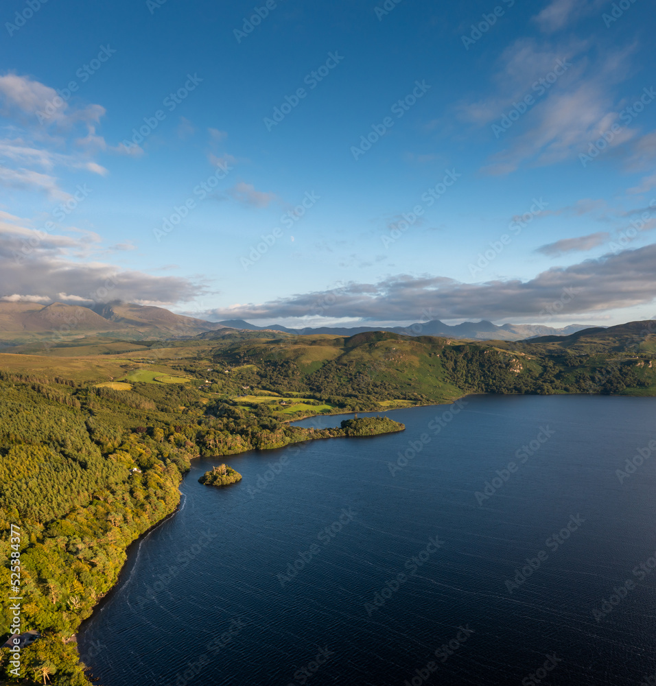 view of Lough Caragh lake in the Glencar Valley of Kerry County in warm eveing light