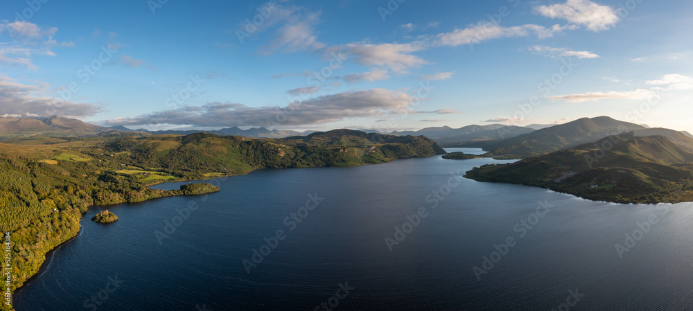 panorama view of Lough Caragh lake in the Glencar Valley of Kerry County in warm eveing light