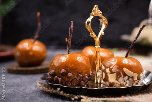 Festive caramel apples on silver serving plate