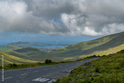 steep and winding mountain road leading to the top of Connor Pass on the Dingle Peninsula
