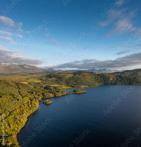 view of Lough Caragh lake in the Glencar Valley of Kerry County in warm eveing light
