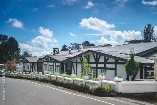 French style one-story wooden white townhouses against bright blue sky. Modern architecture in lovely contryside village. Beautiful classic provencal farmhouse - perfect property to live or invest. photo