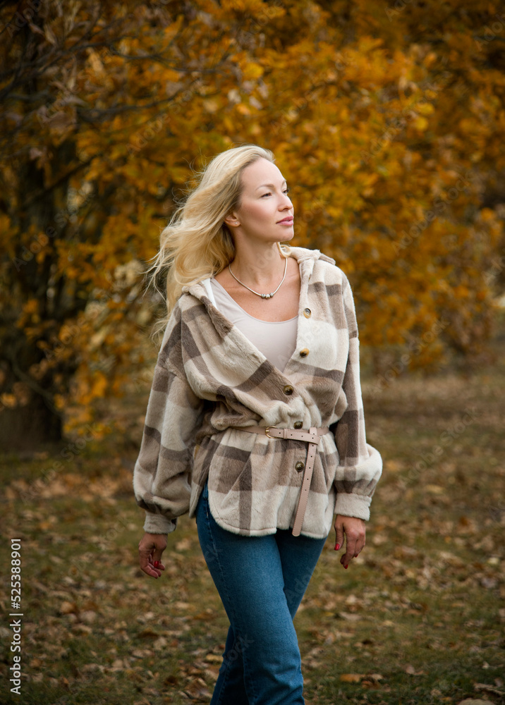 beautiful smiling blond sexy girl with long hair walking in autumn forest beautiful smiling blond sexy girl with long hair walking in autumn forest