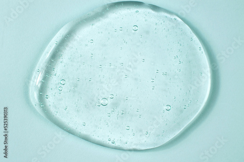 Transparent gel with air bubbles on a blue background. Cosmetics for body care. Laboratory research and development in cosmetology.