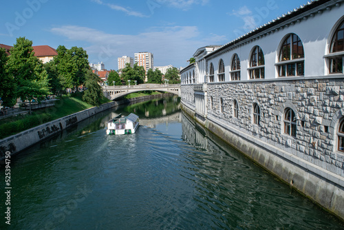 The Ljubljanica River flows past Plečnik's Market toward the residential area of Ljubljana