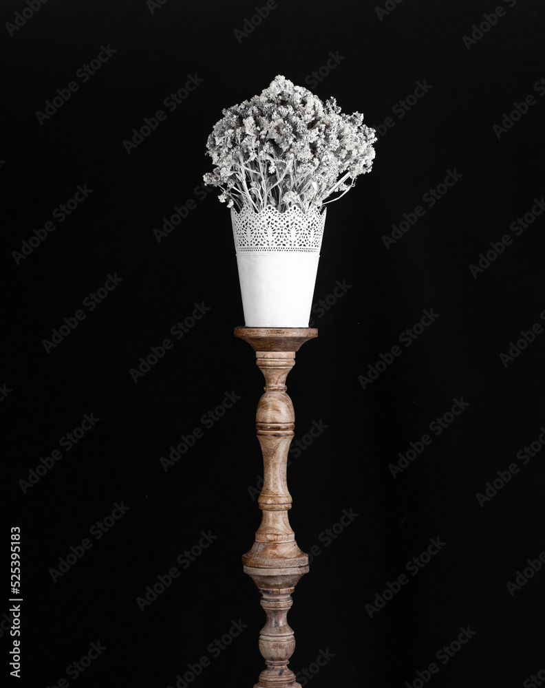 bouquet of white flowers in white vase isolated on black background