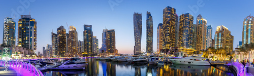 Dubai Marina skyline yacht harbor architecture travel at night twilight panorama in United Arab Emirates