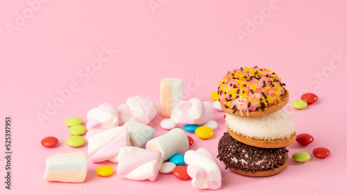 Sweets - cake, sweets, dragees, marshmallows on a pink background