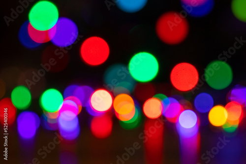 Abstract background with colorful sparkling bokeh on a dark background. Holiday concept