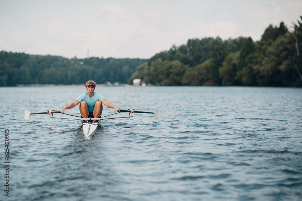 Sportsman single scull man rower rowing technique on boat. Paddle oar splash movement Sportsman single scull man rower rowing technique on boat. Paddle oar splash movement