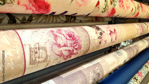 rolls of wrapping paper and oilcloths with ornaments to decorate on a store display - closeup view photo