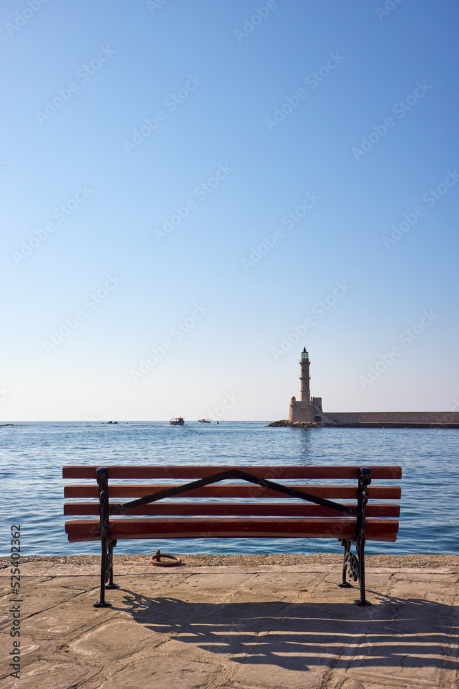 Venetian marina of Chania with bench and lighthouse at sunny day Venetian marina of Chania with bench and lighthouse at sunny day