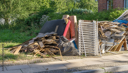 Bulky garbage heap at the roadside with furniture