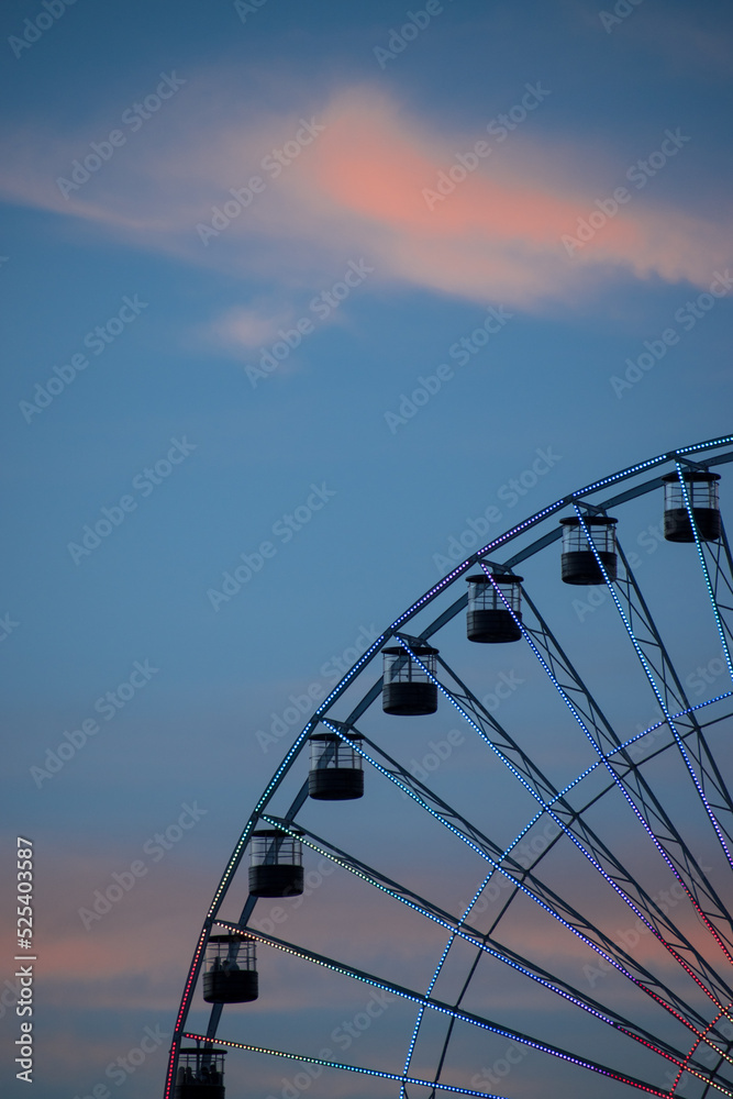 High ferris wheel in a cloudy summer sunset