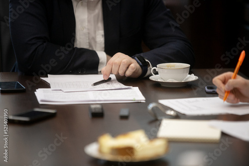 Businessman signing a document after reading the agreement in office