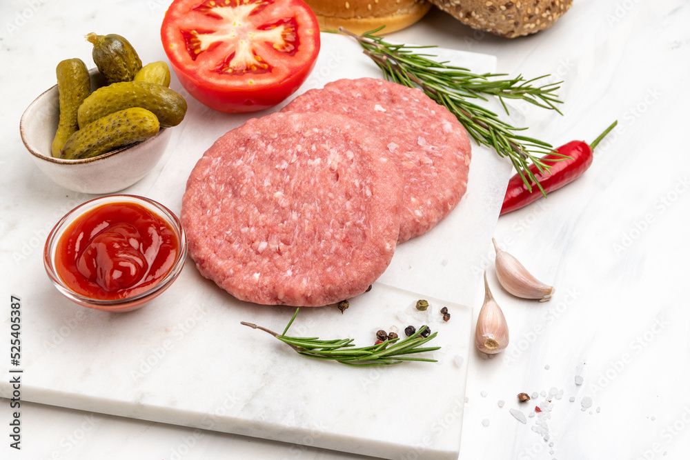 Patty of minced meat for burger. Grey background. Top view Patty of minced meat for burger. Grey background. Top view