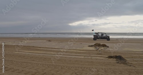 ATV riding along beach at Oceano Dunes SVRA at Pismo Beach, California photo
