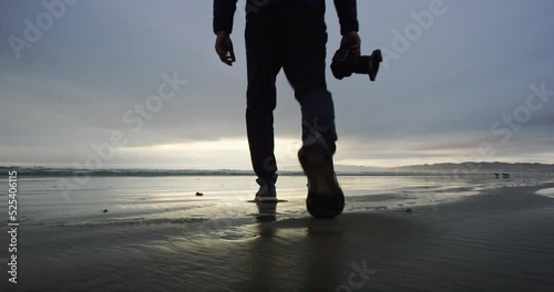 Man walks out towards beach at Oceano Dunes SVRA at Pismo Beach, California photo