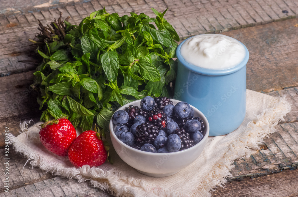 Healthy breakfast Greek yogurt with berries. Bowl of blueberries and blackberries
