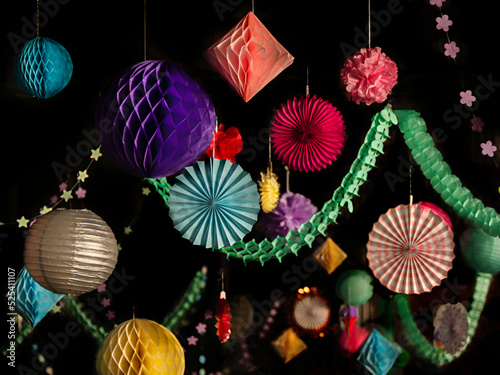 Colorful christmas or party paper lantern, stars, balls decorations on the black background