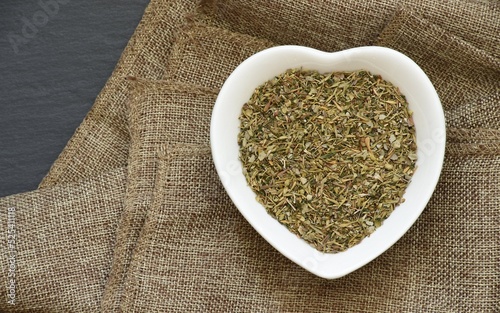 Quadro em tela Image of thyme, marjoram, oregano, parsley, sage and basil mixed in a bowl