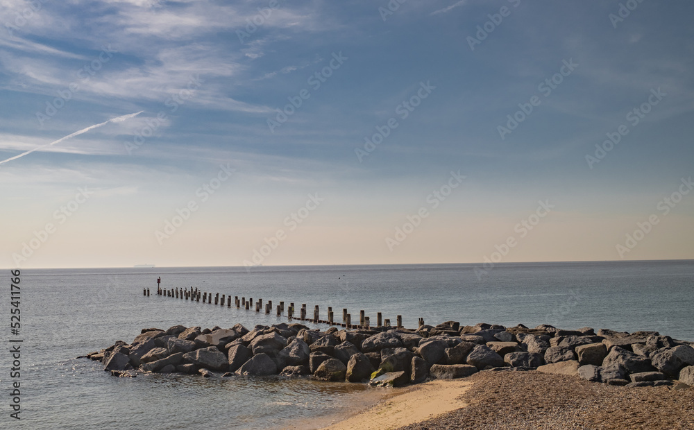 Obraz premium Lowestoft, Suffolk, UK – August 14 2022. View across Lowestoft beach on the Suffolk coast. Captured on a bright and sunny morning