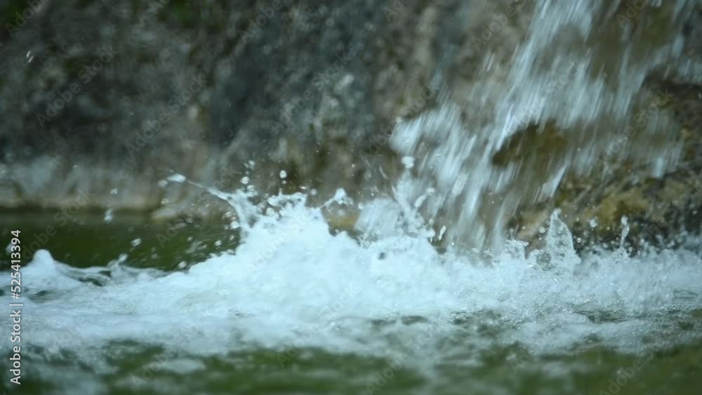 Waterfall flushing into a natural pool in the mountains (slow motion, close up, bokeh, f 1.8) Waterfall flushing into a natural pool in the mountains (slow motion, close up, bokeh, f 1.8)