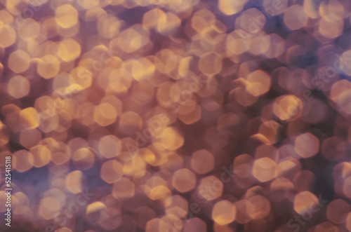 abstract christmas bokeh orange gold background, drops on the glass after rain on sunset looks like a lot of small lights