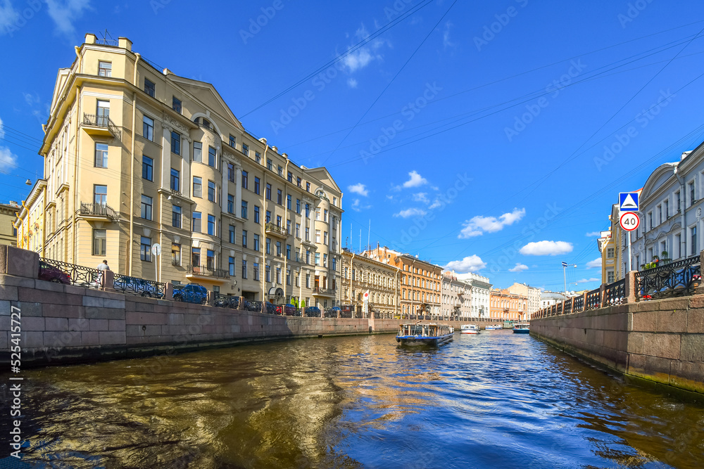Fototapeta premium Tour boats cruise down the Fontanka River in the historic center of Saint Petersburg, Russia.