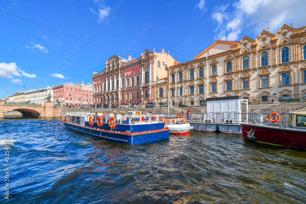 Tourists board small tour boats on the Fotanka River, a channel of the Neva, in the historic center of Saint Petersburg, Russia.