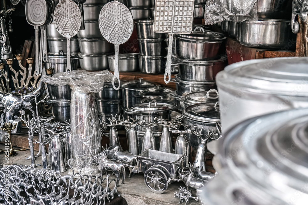 Cooking pots, utensils and souvenirs made from recycled aluminium on  display at local market at Madagascar Photos | Adobe Stock