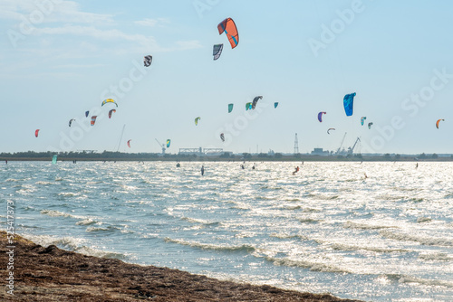 Lots of kites. Sea coast, in the coastal zone there are many extreme sports athletes