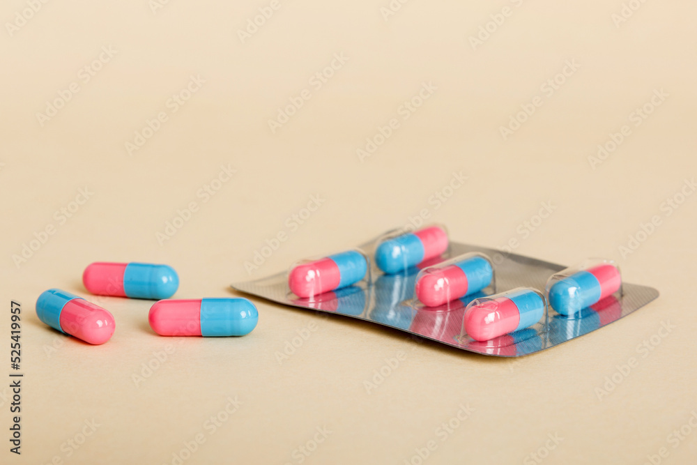 Medicine pills on a light background. Medicines and prescription pills flat lay background. Blue and pink medical tablets in blister Medicine pills on a light background. Medicines and prescription pills flat lay background. Blue and pink medical tablets in blister