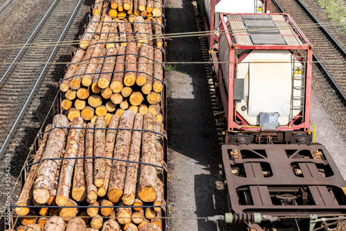 Above view of railway sorting station with many lines directions in Germany. Railroad car wooden timber logs and gas tanks logistics. Raw wood heating material transportation. Freight cargo transport photo