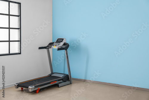 Modern treadmill in stylish...