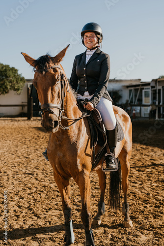 vertical portrait of a student riding a horse from an equestrian school © Samuel Perales
