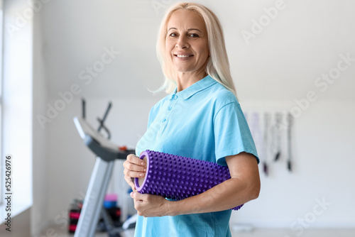 Smiling mature woman holdin...
