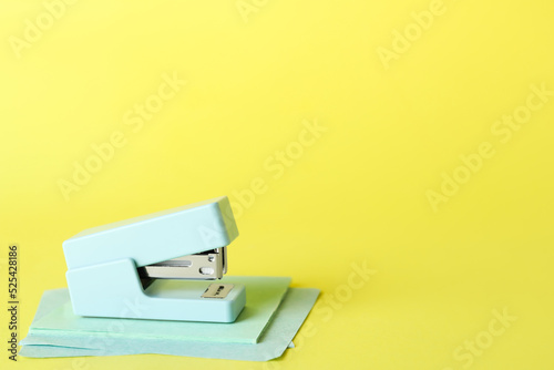 Light blue stapler with gre...