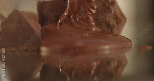 Hot black chocolate spreads on a mirror surface