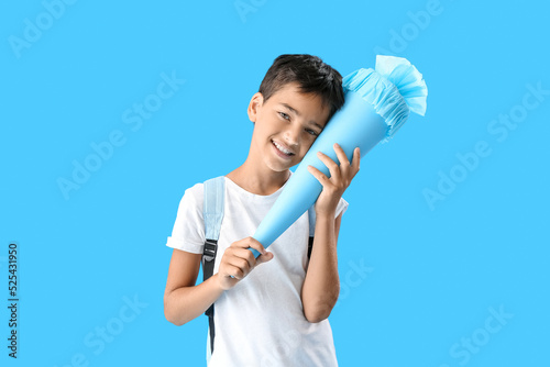 Little boy with school cone...