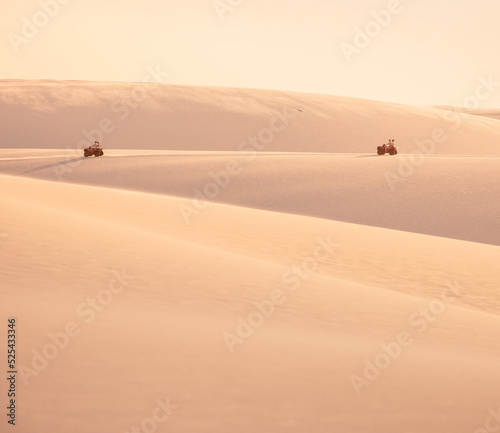 quads driving through the sand dunes in the desert