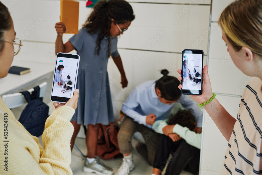 School bullying scene with children recording fight on smartphone camera and posting it to