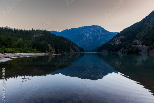 sunrise in still turquoise water of Thunder Arm in Diablo lake in Colonial Creek Campground in North Cascade National park  Washington